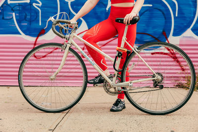 Low section of man with bicycle on street