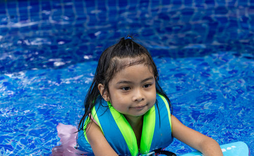 Portrait of cute child in swimming pool