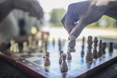 Close-up of two men playing game of chess