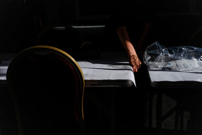 Cropped hand of woman straightening table cloth