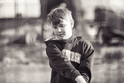 Cute boy looking away while playing outdoors