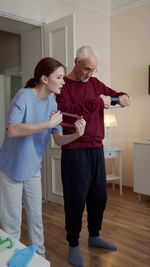 Side view of mother and daughter standing in office