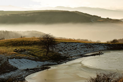 Fog covered hills during winter in romania