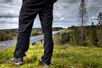 Low section of man standing on land