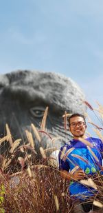 Portrait of a smiling man sitting on landscape