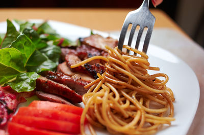 Close-up of noodles served in plate on table