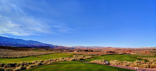 Scenic view of landscape against blue sky