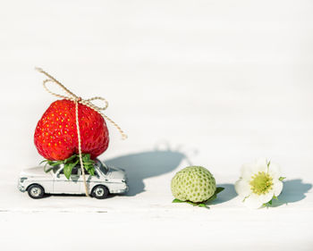 Close-up of strawberries on table against white background