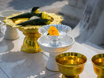 High angle view of yellow roses in vase on table