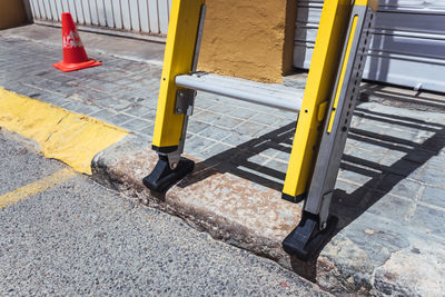 High angle view of yellow chair on road