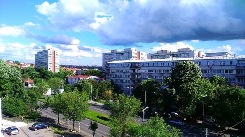 Panoramic view of trees and buildings against sky