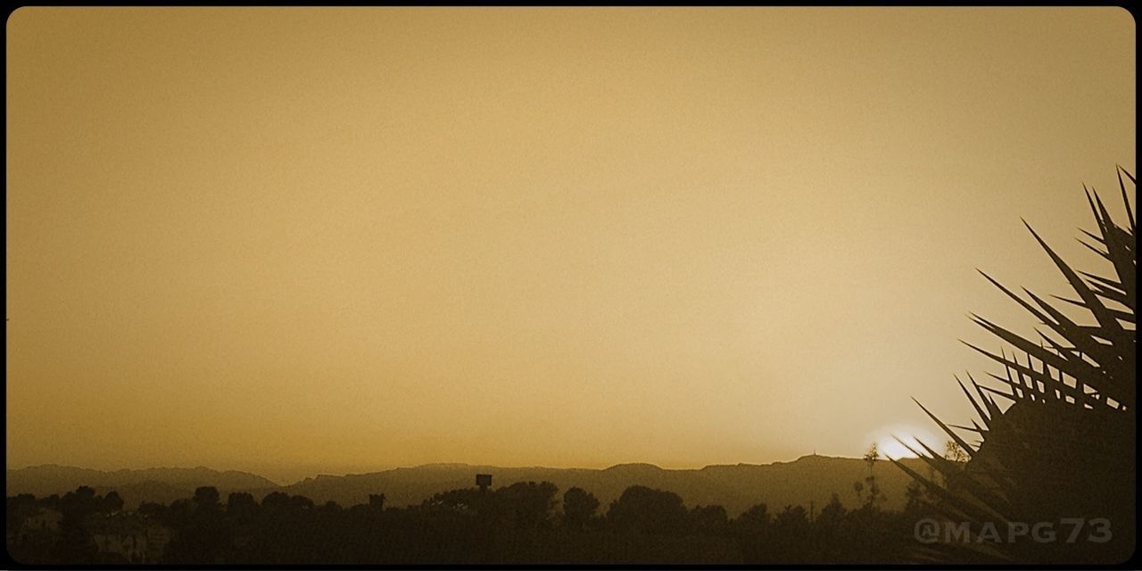 VIEW OF LANDSCAPE AGAINST CLEAR SKY AT SUNSET