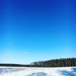 Snowcapped landscape against clear blue sky