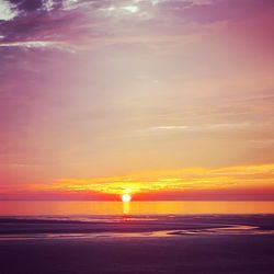 Scenic view of sea against romantic sky at sunset