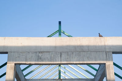 Low angle view of bridge against clear blue sky