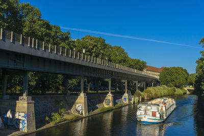 View of bridge over river against blue sky