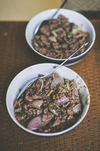 Close-up of beef and onion served in bowls