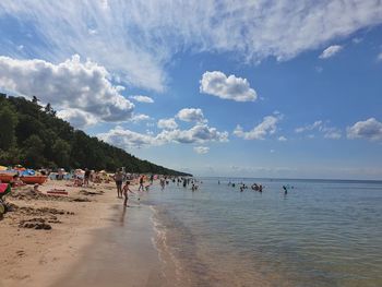 People on beach against sky