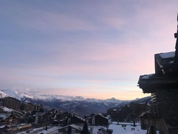 Buildings in city against sky during winter