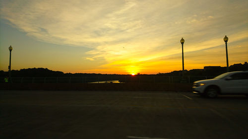 Cars parked in parking lot at sunset