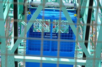 Ferris wheel seen through metal