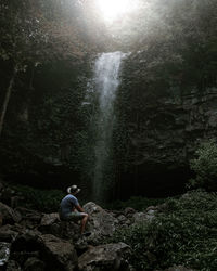 Man surfing on rock in forest