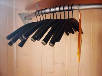 Close-up of piano hanging on wooden wall at home