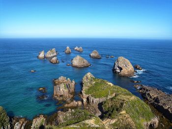 Scenic view of sea against clear blue sky