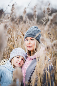 Portrait of smiling young woman wearing hat on field