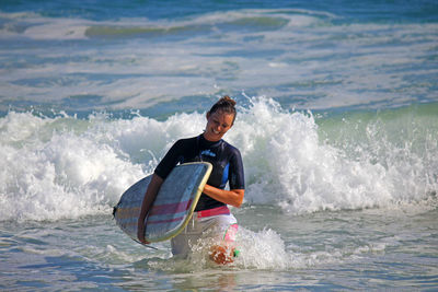Woman jumping in sea