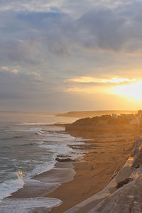 Scenic view of beach against sky during sunset