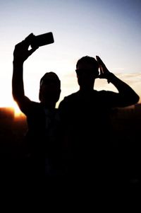 Silhouette of people at sunset