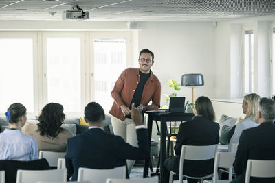 Group of business people attending presentation during conference