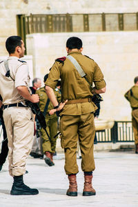 Rear view of siblings walking in building