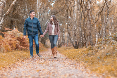 Man and woman walking in forest