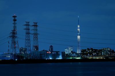 Illuminated city against sky at night