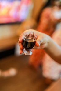 Midsection of person holding wineglass