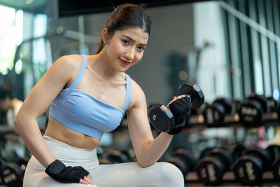 Side view of woman exercising in gym