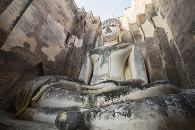 Sculpture of buddha statue outside historic building