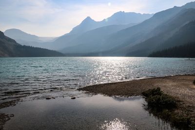 Scenic view of lake and mountains against sky