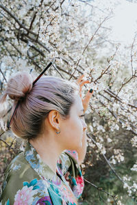 Portrait of young woman with cherry blossom