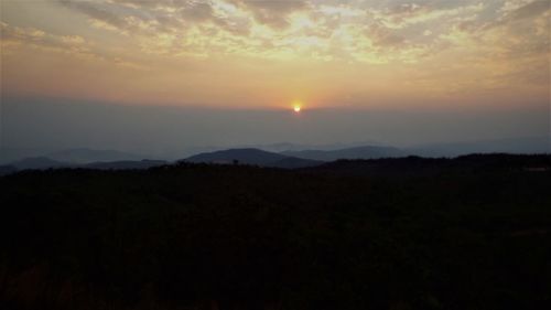Scenic view of silhouette mountain against sky during sunset