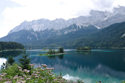 Scenic view of lake and mountains against sky