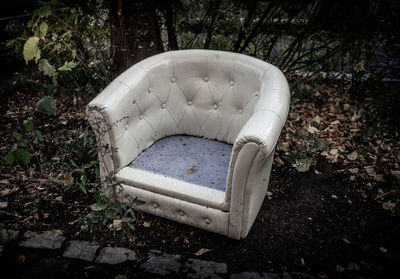 Abandoned armchair on land