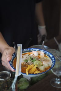 Cropped hand of woman holding food