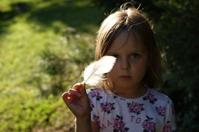 Portrait of girl holding plant