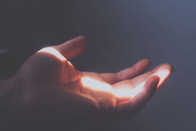 Close-up of human hand against black background