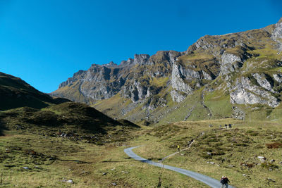 Scenic view of mountains against clear blue sky