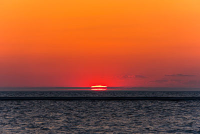 Scenic view of sea against romantic sky at sunset