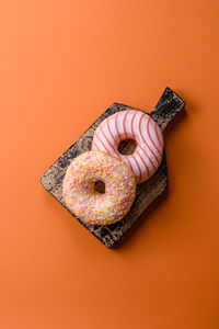 High angle view of donuts on yellow background
